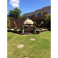 Brown rattan day bed with cream cushions and hood