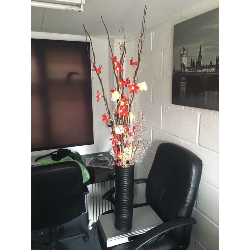 False flowers in vase with lights