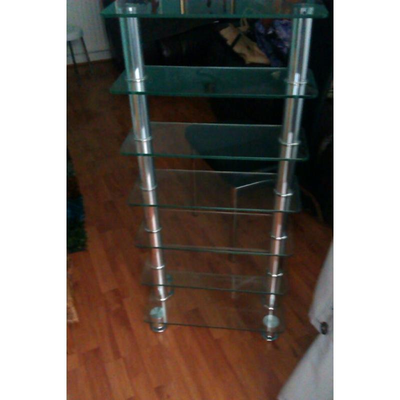 SOLID THICK GLASS CD/DVD DISPALY UNIT WHICH CAN ALSO BE USED AS A BOOK SHELF. MATCHES ANY FURNITURE