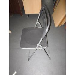 2 Folding chairs . Black colour . Plastic and metal .