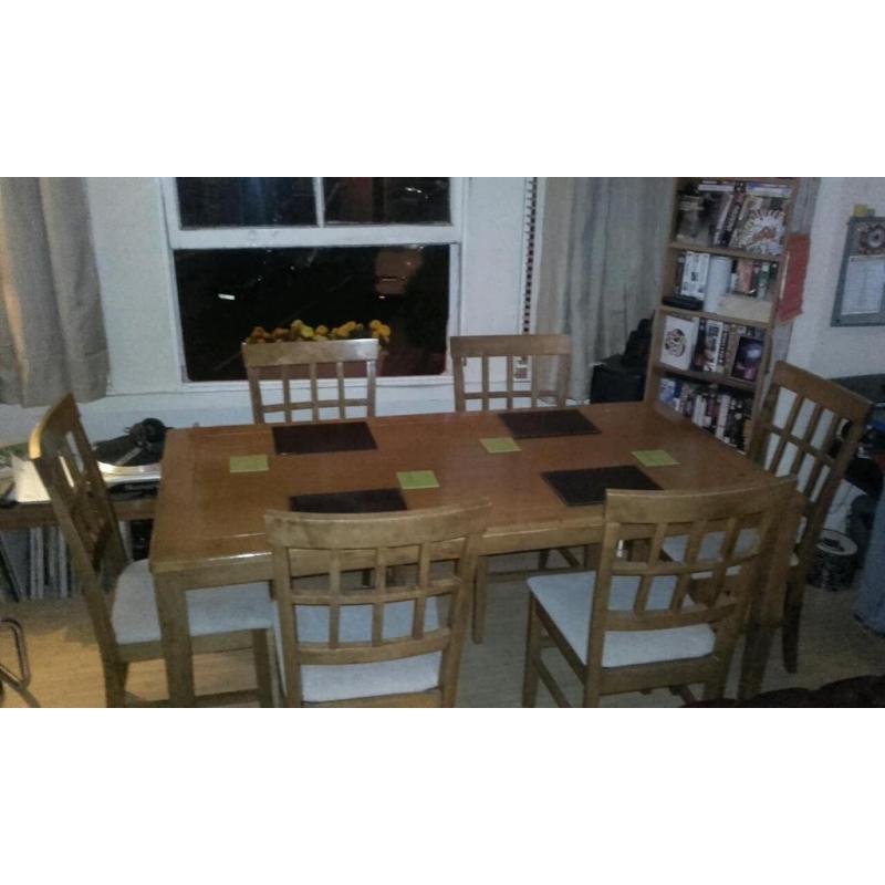 Large wooden dining table with 6 chairs. Lovely condition and quality.