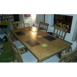 Large wooden dining table with 6 chairs. Lovely condition and quality.