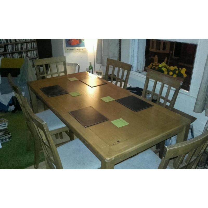 Large wooden dining table with 6 chairs. Lovely condition and quality.