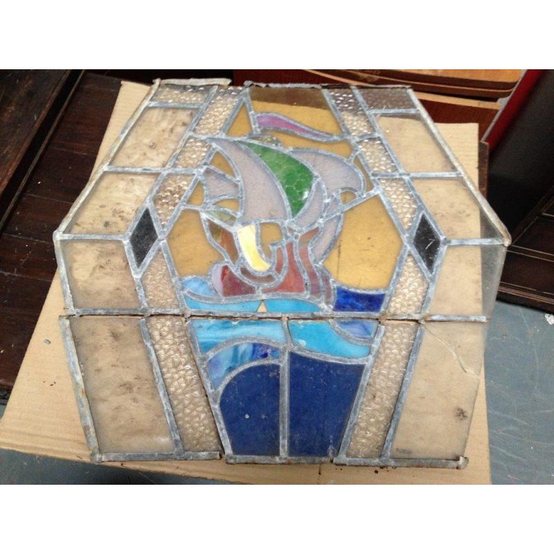 Hexagonal vintage stained glass window in need of restoration