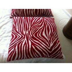 2 red zebra print cushions and red rectangle cushion