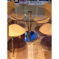 Round glass top table from m&s ,and 4 chairs from next .hardly used very good condition