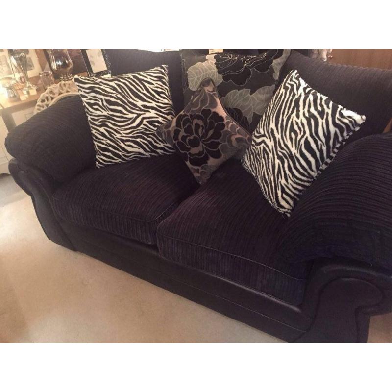 black 2 seater sofa with cushions