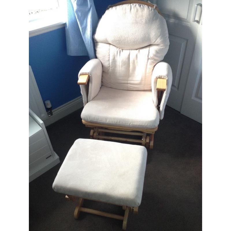 Glider reclining nursing chair and foot stool, cream coloured covers.