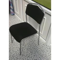 Ikea Chair in grey metal, with black upholstery.