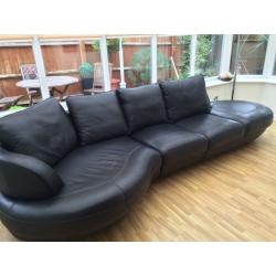 Black leather 5 seater corner sofa and footstool