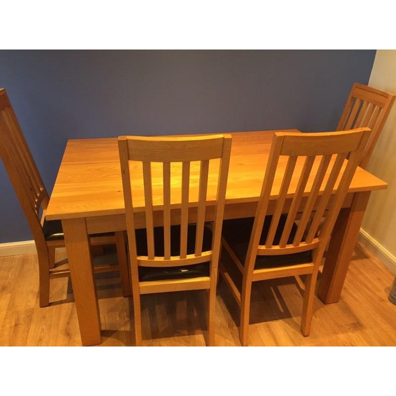 Solid oak dining table and chairs