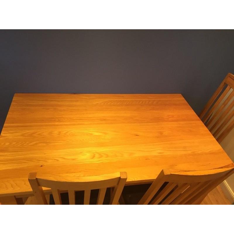 Solid oak dining table and chairs