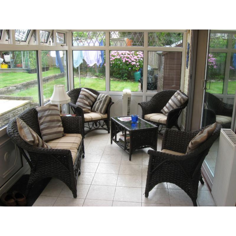 Five piece conservatory suite comprising of settee, three chairs and coffee table.