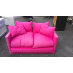 Small pink sofa bed. Good condition.