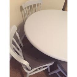 Grey kitchen dining table with four chairs and grey seat covers