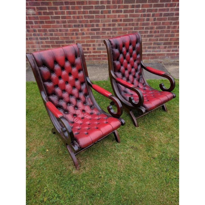 2 Chesterfield blood red leather and dark wood framed chairs in good condition for age