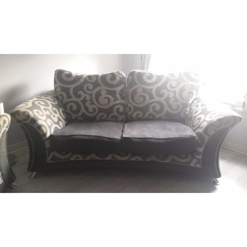 2 grey sofas with footstool