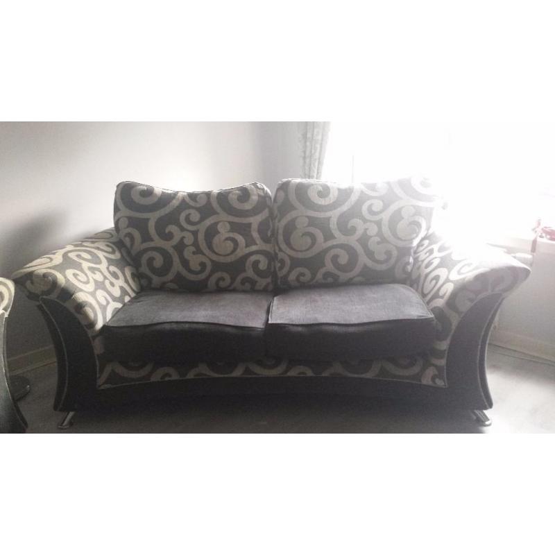 2 grey sofas with footstool