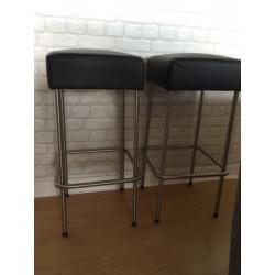 Two Ikeas faux leather bar stools