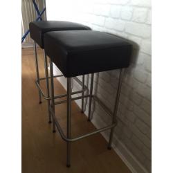 Two Ikeas faux leather bar stools