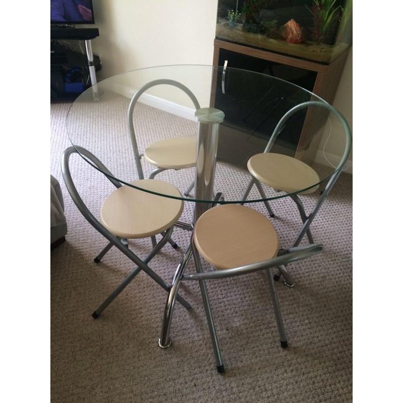 Round glass table with chairs