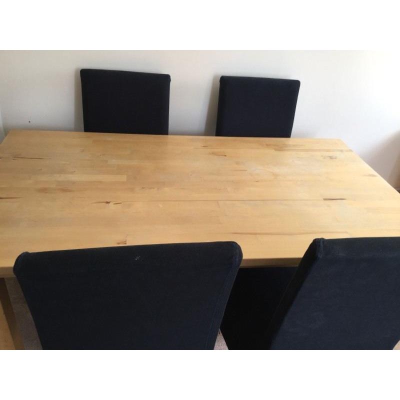 Wooden table with four high backed chairs