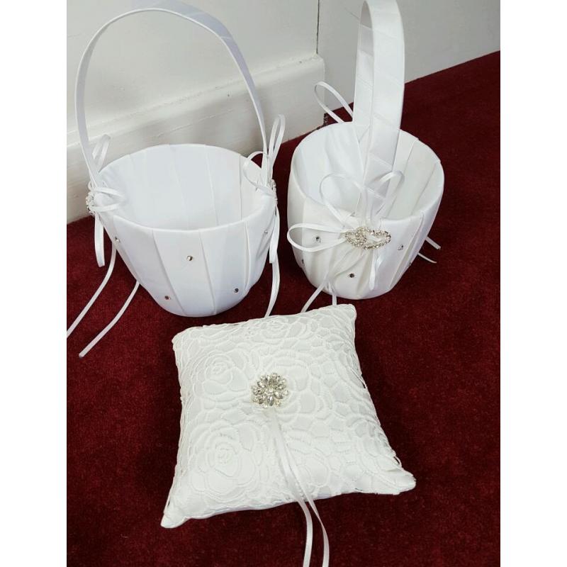 2 white satin flower girl baskets and off white ring cushion