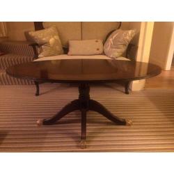 Oval pedestal mahogany coffee table