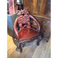 Oriental carved armchair , reproduction . Lovely carved detail.