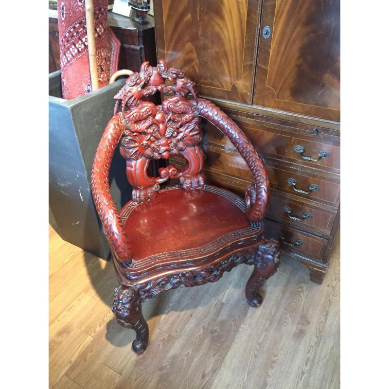 Oriental carved armchair , reproduction . Lovely carved detail.