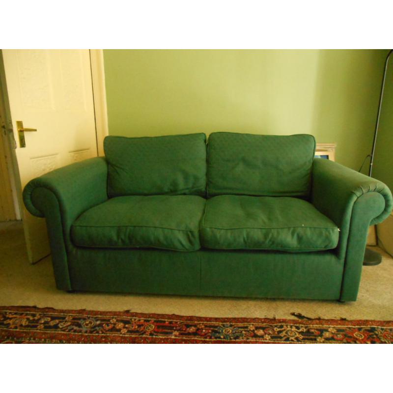 Green cotton sofa, free. Worn but serviceable. Feather cushions. Buyer to collect