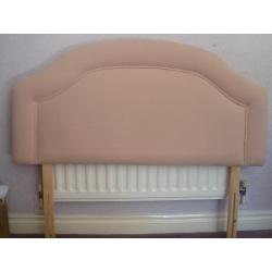 A neutral coloured fabric headboard suitable for a small double bed (4 ft)