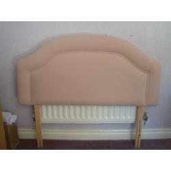 A neutral coloured fabric headboard suitable for a small double bed (4 ft)