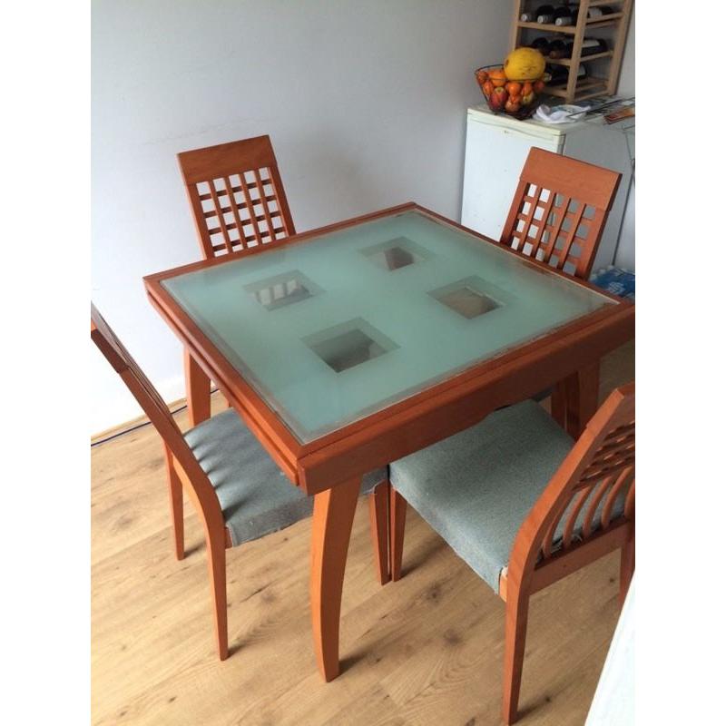 Glass top, wooden legs extendable dining table and 6 chairs