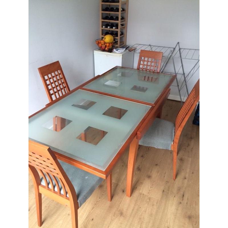 Glass top, wooden legs extendable dining table and 6 chairs